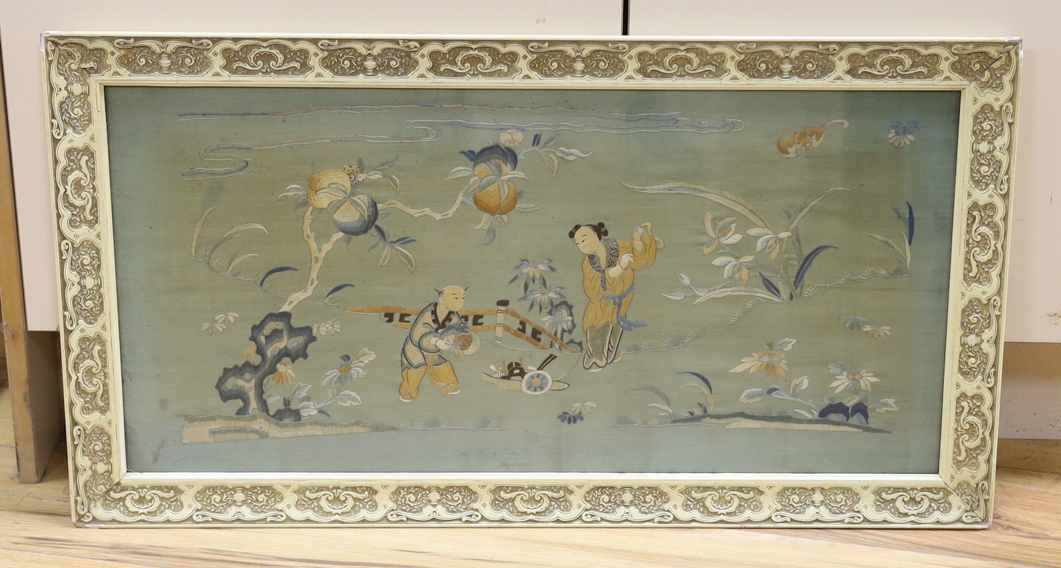 A 19th century framed Chinese polychrome silk embroidered panel, 68 cms wide x 34 cms high.